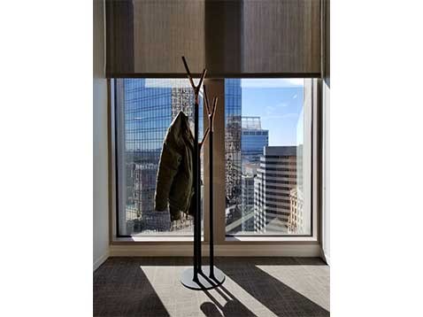 Sunlight coming through a window illuminating a jacket on a stand