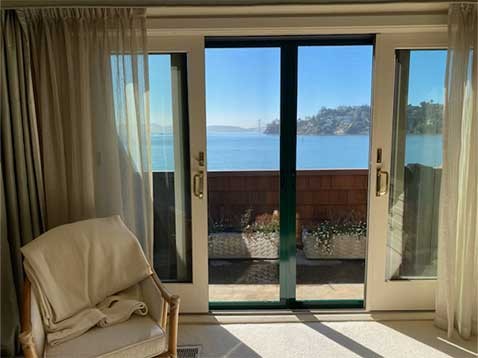A double glass door with a view of the ocean